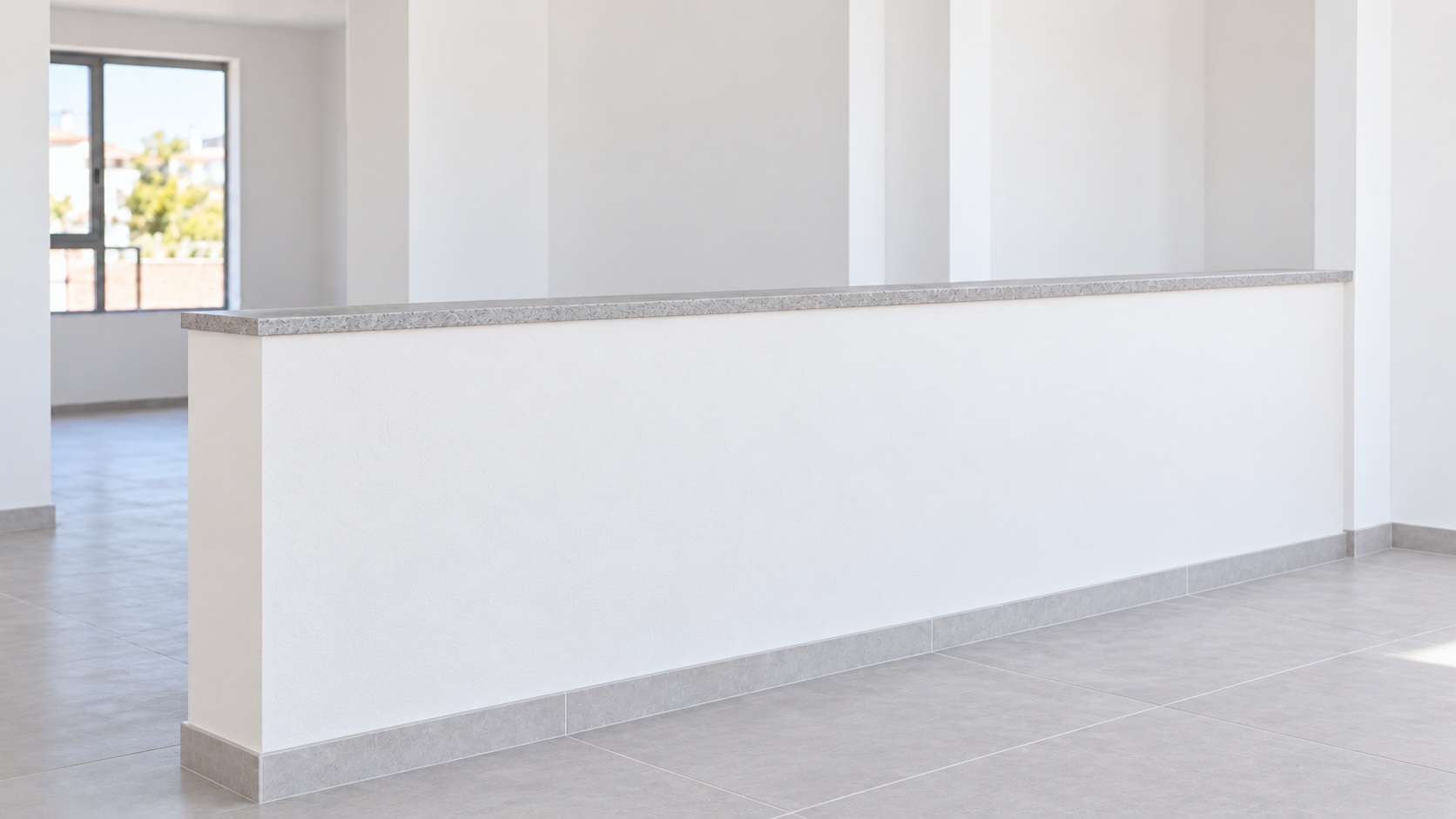 El mismo murete divisorio terminado, revestido en blanco y rematado con piedra gris